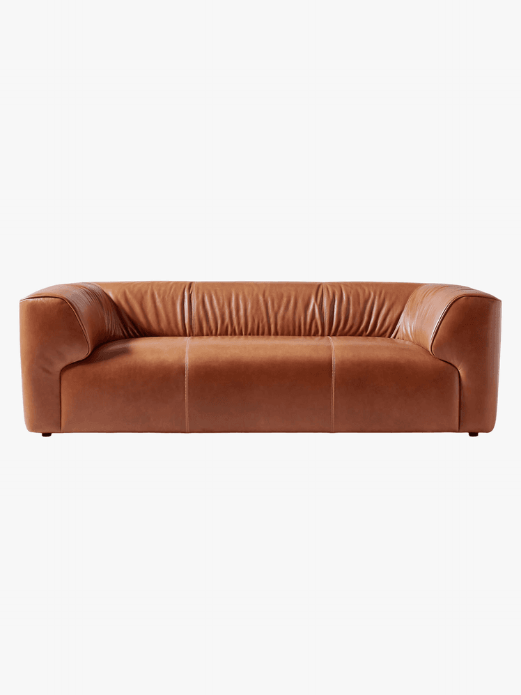 Brown leather couch with rounded back